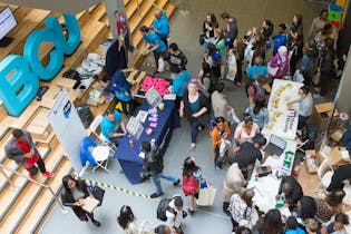 Image of students in hall meeting with employers