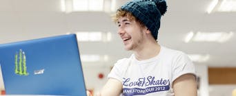 Photo of student on laptop smiling