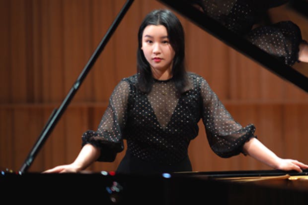 Hejie Zhong behind piano