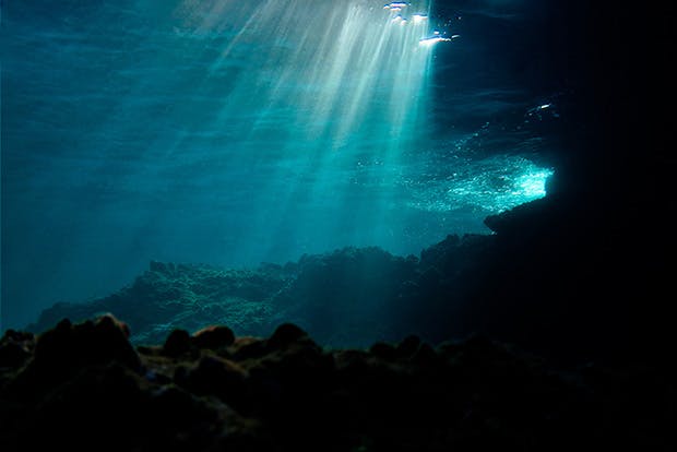 Undersea grotto with dappled sunlight