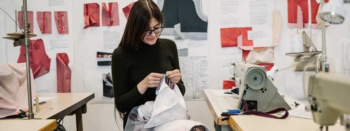 A student working on a piece of clothing