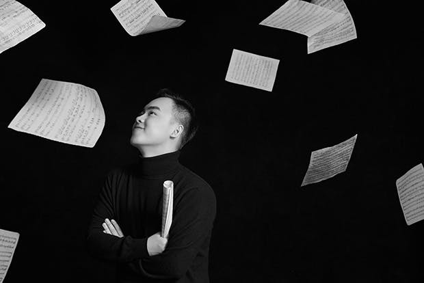 Tingguang Li with falling music manuscript