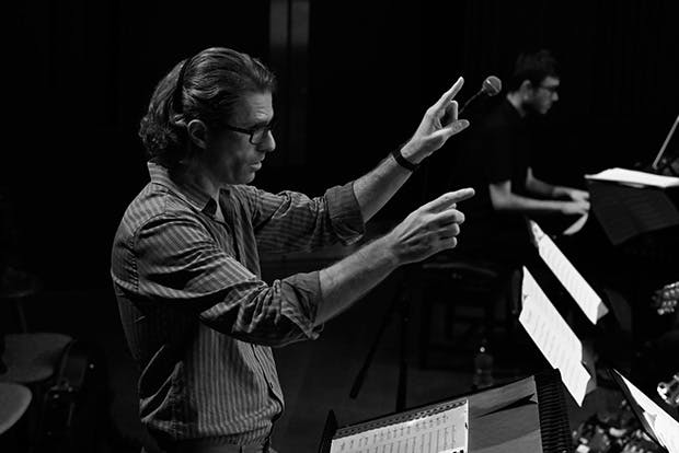 Black and white photo of Ed Puddick conducting