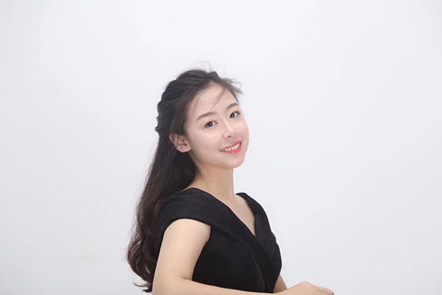 Pianist Ke Qiao against white background