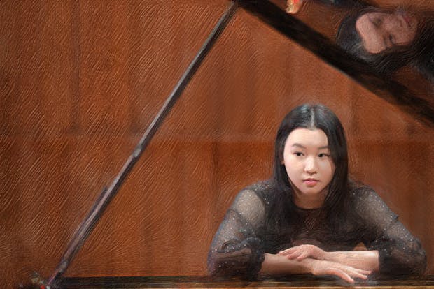 Photo of pianist Hejie Zhong at piano with paint filter