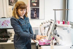Student by embroidery machine