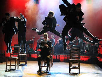 Acting students jumping from chairs
