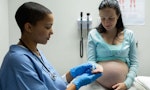 Medical professional monitoring pregnant woman
