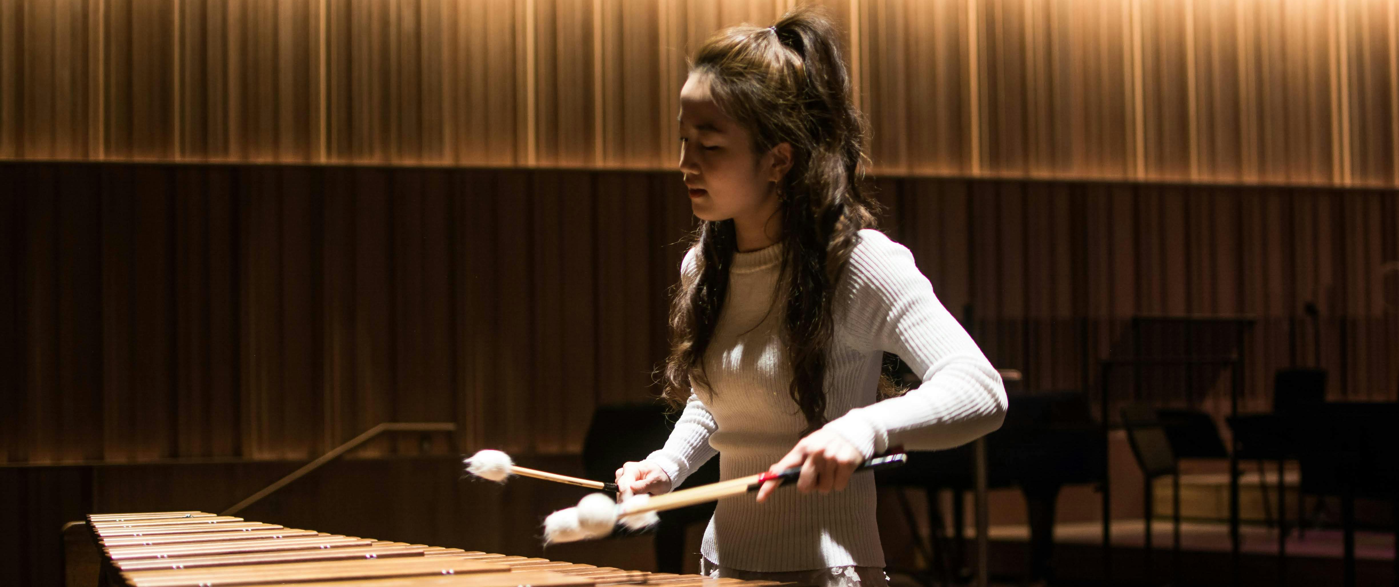 APD student Tzu-Jo Huang. Photo Alex Henshaw. Student playing xylophone in dark room
