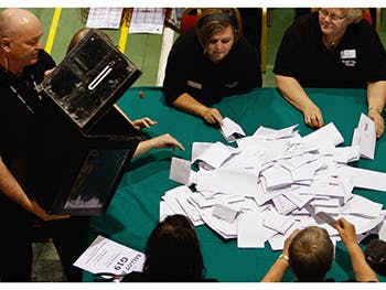 A ballot box is emptied on a table at a count