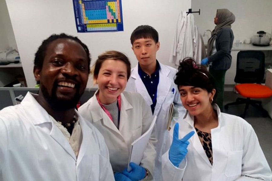 Barickeh Koroma with colleagues in lab coats