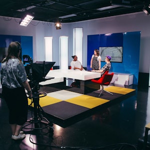 Students in Studio D newsroom set