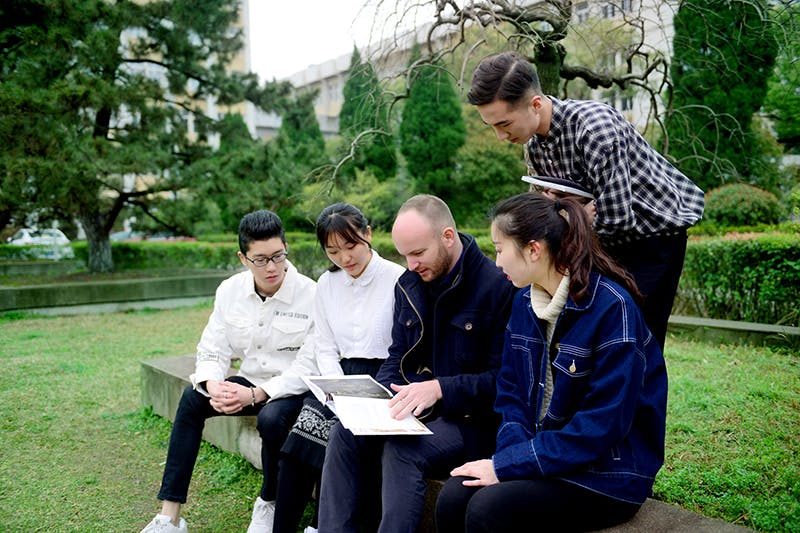 Lecturer and students outside campus