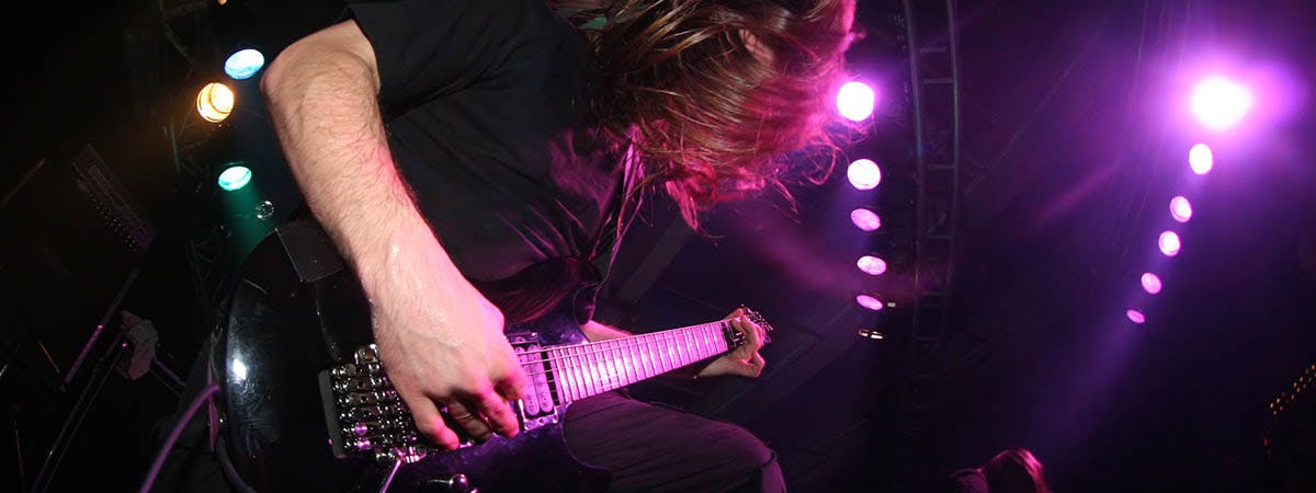 Black Metal Glocalisation 1200x450 - Man playing a guitar