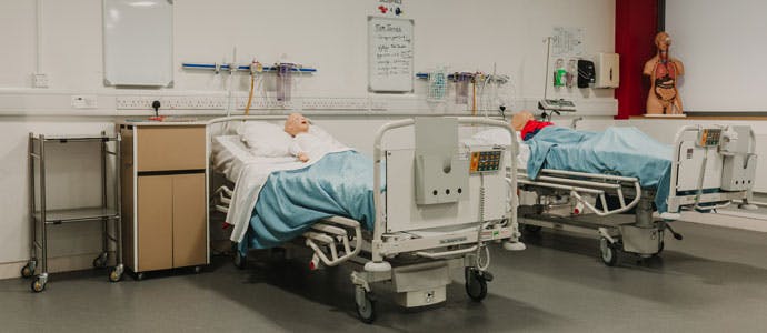 Mock wards with hospital beds and simulation dummies