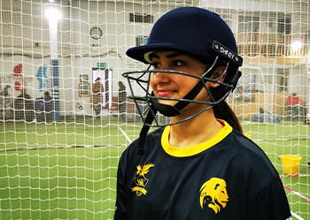 BCU female cricket player in sports hall