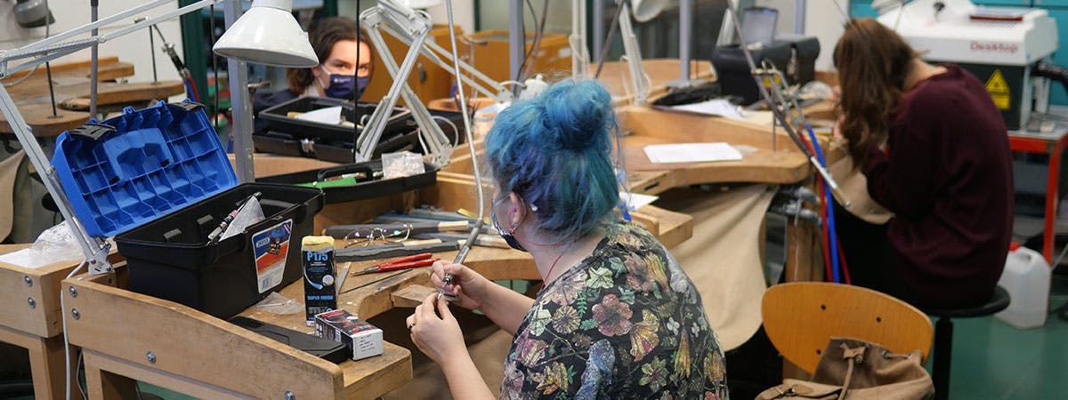 Jewellery students working in the studio wearing face coverings
