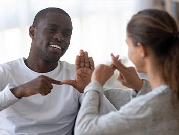 Two people communicating via sign language
