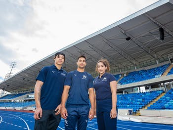 BCU sports students Thierry Anderson Taylor, Joshua Nathan and Anisa Hussain in front of the Alexander Stadium West Stand