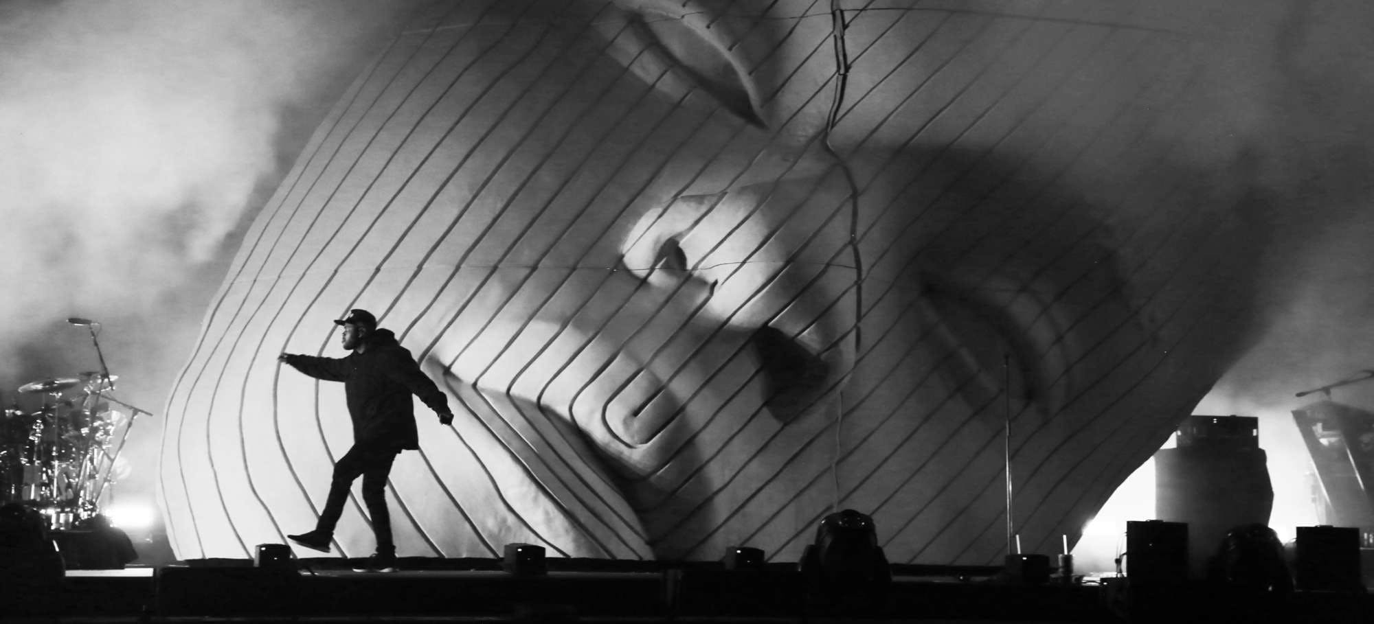 Black and white image of Es Devlin's set design for The Weeknd featuring a backdrop of his face