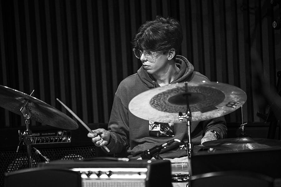 Ethan Wood - black and white - playing drums