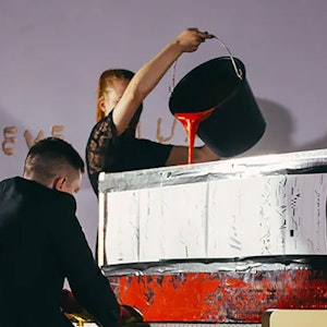 Experimental performance - piano playing with red paint poured in