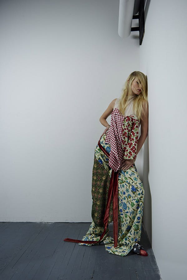 Fashion Imaging - woman leaning against wall wearing lots of different patterns