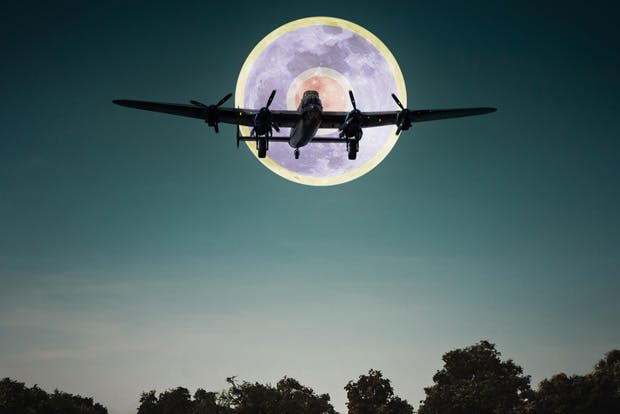 Lancaster bomber flying in front of the moon with RAF roundel superimposed