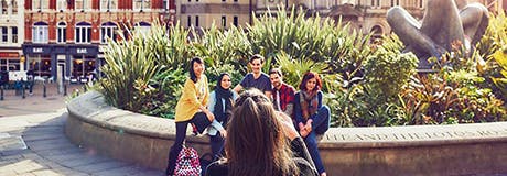 Students posing for photograph in Victoria Square Birmingham.