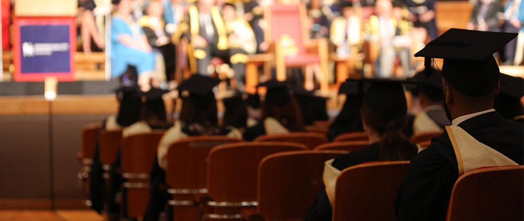 Graduates seated in Symphony Hall at graduation