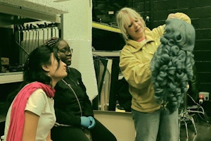 Students using a wig for costume purposes