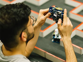 Image of student holding circuit board