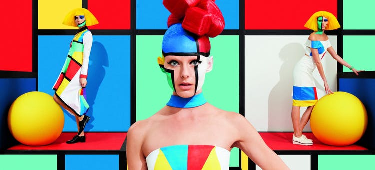 Colourful image of models in front of grid background, composed of primary colours