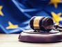 Judges wooden gavel with EU flag in the background