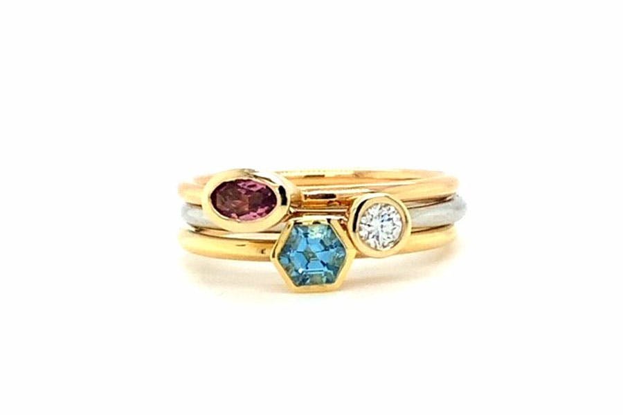 Three gold and silver stacking rings with coloured gems by Karen McKinley 