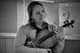 Black and white photo of Louise Lansdown hugging a viola