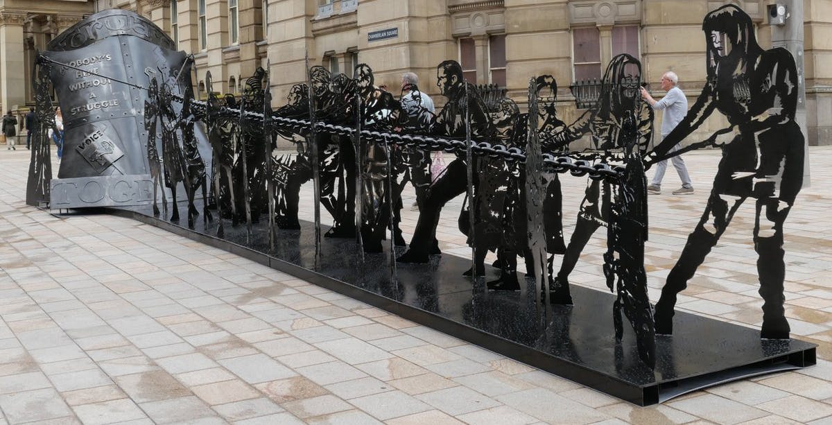 Image of Birmingham city centre art installation, featuring to-scale black metal sculptures of various members of the community past and present