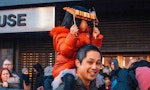 A photo of a man with a child on his shoulders