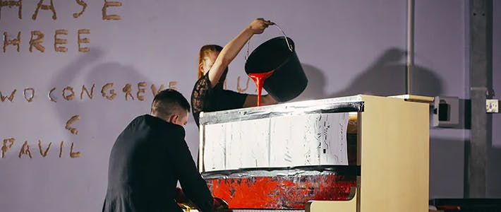 Experimental performance with piano and red paint