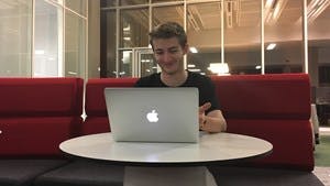 Dan McDonald working at his Mac laptop.