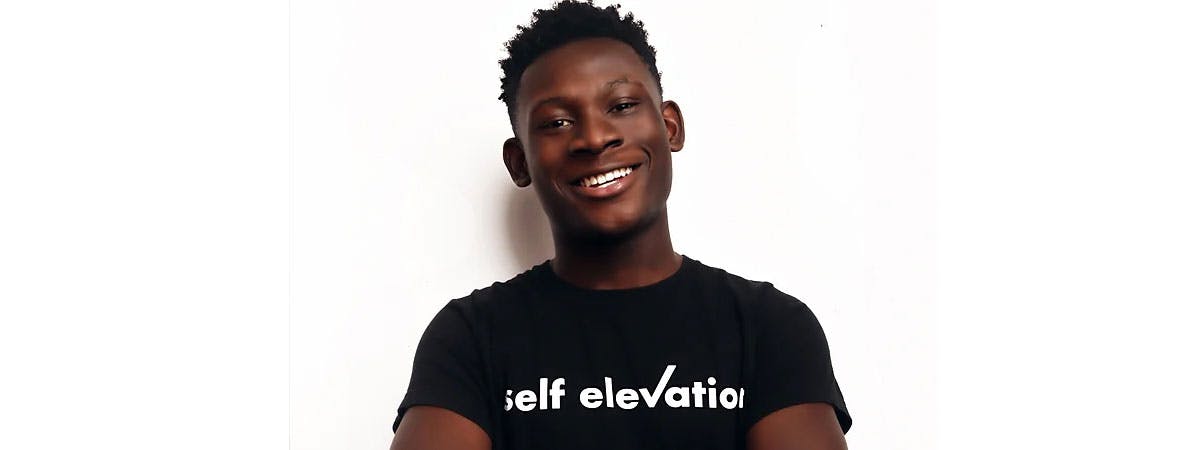 Poku banks smiles at the camera in front of a plain white background