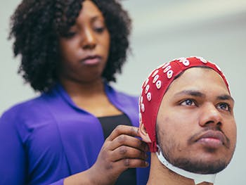 Psychology 2 Course Image 350x263 - Woman putting an ECG cap on a man