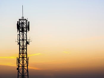 A radio mast against a sunset
