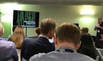 A room of people listening to a talk