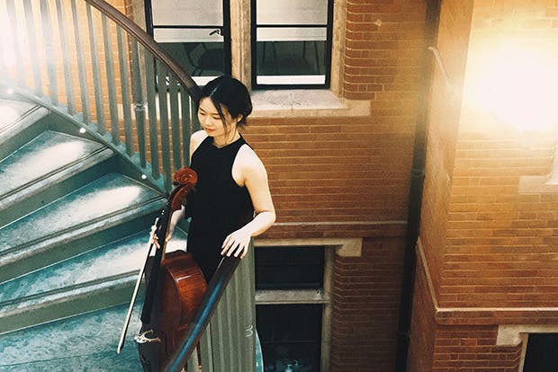 Cellist Sizhe Fang on staircase
