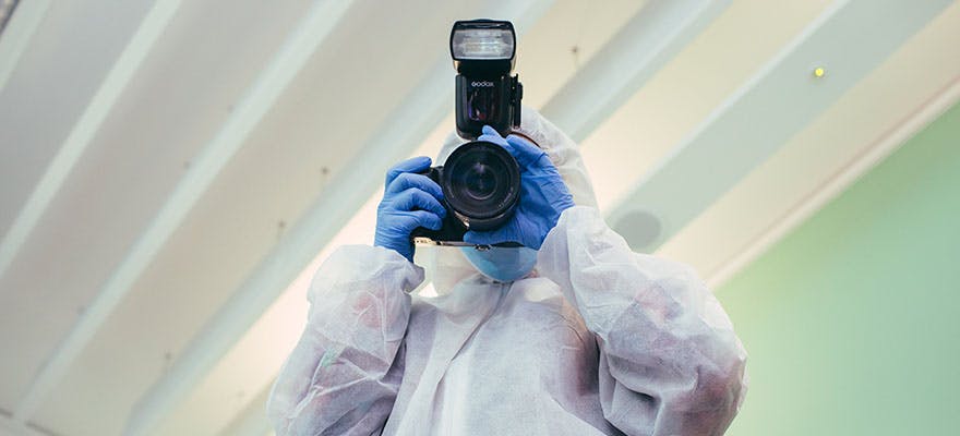 The Branches of Social Sciences Explained Criminology 880x400 - Person holding a camera in a crime scene suit