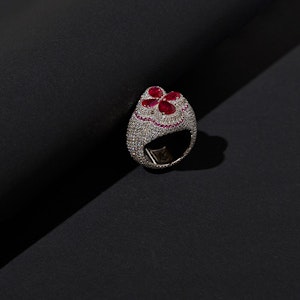 Silver bejewelled ring with red gem