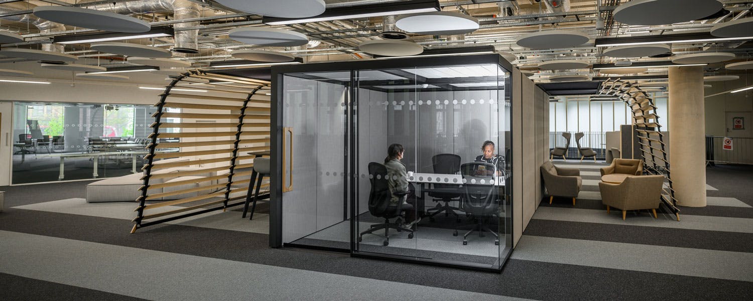 People in an enclosed meeting room in the Steamhouse building